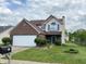 Charming two-story home with brick and vinyl siding, manicured lawn and mailbox at 621 Jack Pine Ct, Indianapolis, IN 46224