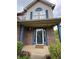 Inviting front door with brick accents and a 'Welcome' mat, creating a warm entry at 621 Jack Pine Ct, Indianapolis, IN 46224