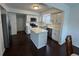 Modern kitchen with white cabinets, stainless appliances, quartz counters, kitchen island and hardwood floors at 621 Jack Pine Ct, Indianapolis, IN 46224