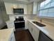 Bright kitchen featuring stainless steel appliances, white cabinets, quartz counters, and a large sink at 621 Jack Pine Ct, Indianapolis, IN 46224