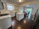 Bright kitchen with stainless steel appliances, an island, and access to the dining and patio area at 621 Jack Pine Ct, Indianapolis, IN 46224