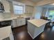 Updated kitchen with white cabinets, stainless appliances, and island overlooking outdoor dining at 621 Jack Pine Ct, Indianapolis, IN 46224