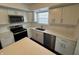 Well-lit kitchen with stainless appliances, white cabinets, quartz counters, and hardwood floors at 621 Jack Pine Ct, Indianapolis, IN 46224