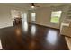 Bright living room boasts hardwood floors, neutral walls, two windows, and a dining area with table and chairs at 621 Jack Pine Ct, Indianapolis, IN 46224