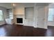 Inviting living room featuring a fireplace with built-in shelving and hardwood floors at 621 Jack Pine Ct, Indianapolis, IN 46224