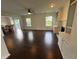 Open living room featuring hardwood floors, natural light, ceiling fan and access to a dining area at 621 Jack Pine Ct, Indianapolis, IN 46224