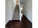 Clean and bright view of a staircase, hardwood floors, and neutral walls at 621 Jack Pine Ct, Indianapolis, IN 46224