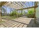 Spacious wooden back deck with a wooden pergola, overlooking a lush backyard with green trees at 6307 Broadway St, Indianapolis, IN 46220