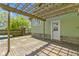 A wooden deck with a pergola and a back door leading into the house, exterior light green siding at 6307 Broadway St, Indianapolis, IN 46220