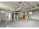 Large, unfinished basement space with painted floor and white-painted ceiling at 6307 Broadway St, Indianapolis, IN 46220