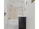 Compact bathroom with a black vanity, a tiled shower-tub combination, and a classic aesthetic at 6307 Broadway St, Indianapolis, IN 46220