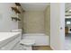 Updated bathroom with tile shower and tub, wooden shelves, and a sleek vanity at 6307 Broadway St, Indianapolis, IN 46220