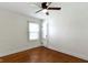 Serene bedroom with hardwood floors, neutral walls, and ceiling fan at 6307 Broadway St, Indianapolis, IN 46220