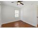 A well-lit bedroom with hardwood floors, white trim, and a ceiling fan at 6307 Broadway St, Indianapolis, IN 46220