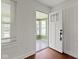 Entryway with white door and view into sunroom with many windows and natural light at 6307 Broadway St, Indianapolis, IN 46220
