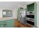 Spacious kitchen with stainless steel appliances and modern green cabinets at 6307 Broadway St, Indianapolis, IN 46220