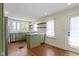 Well-lit kitchen with green cabinetry, stainless steel appliances, and center island at 6307 Broadway St, Indianapolis, IN 46220