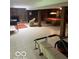 Spacious finished basement with a pool table, stone fireplace, and exercise equipment at 650 Balroyal Ct, Indianapolis, IN 46234