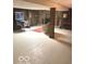 Spacious basement with a stone fireplace, pinball machine, and tile floor at 650 Balroyal Ct, Indianapolis, IN 46234