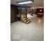 Finished basement featuring a staircase, stone fireplace and pool table at 650 Balroyal Ct, Indianapolis, IN 46234