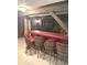 Finished basement bar area with barrel themed bar stools and wood paneled walls at 650 Balroyal Ct, Indianapolis, IN 46234