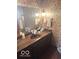 Floral-themed bathroom boasting a large mirror, and wood vanity at 650 Balroyal Ct, Indianapolis, IN 46234