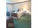 Cozy bedroom with floral accents, carpet flooring, and side table with a lamp at 650 Balroyal Ct, Indianapolis, IN 46234