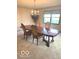 Traditional dining room with elegant chandelier, wallpaper, and large window at 650 Balroyal Ct, Indianapolis, IN 46234