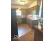 Traditional kitchen featuring wood cabinets, black appliances, and wood flooring at 650 Balroyal Ct, Indianapolis, IN 46234