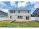 Back exterior of the house showing the patio, well-maintained lawn, and white vinyl fence at 6827 Fallen Leaf Dr, Whitestown, IN 46075