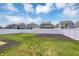 Backyard of a home featuring a white fence, a green lawn, and mulch beds at 6827 Fallen Leaf Dr, Whitestown, IN 46075