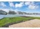 Spacious backyard featuring a well-maintained lawn, brick patio, and white vinyl fence at 6827 Fallen Leaf Dr, Whitestown, IN 46075