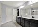 Bathroom features a double sink, dark cabinets, and neutral colored walls at 6827 Fallen Leaf Dr, Whitestown, IN 46075