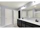 Bathroom featuring a double vanity with modern fixtures, a large mirror, and a shower at 6827 Fallen Leaf Dr, Whitestown, IN 46075