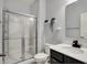 Bathroom featuring shower with sliding glass doors, black hardware, and white single sink vanity at 6827 Fallen Leaf Dr, Whitestown, IN 46075