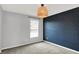 Bedroom featuring a modern light fixture and a dark accent wall at 6827 Fallen Leaf Dr, Whitestown, IN 46075