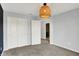 A bright bedroom with a woven light fixture and a neutral color scheme at 6827 Fallen Leaf Dr, Whitestown, IN 46075