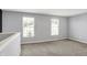 Bonus room features carpet flooring and natural lighting from the windows at 6827 Fallen Leaf Dr, Whitestown, IN 46075