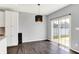 Dining area featuring hardwood floors, a modern light fixture, and a sliding door to backyard at 6827 Fallen Leaf Dr, Whitestown, IN 46075