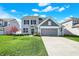 Charming two-story home featuring a well-manicured lawn, attached garage, and delightful curb appeal at 6827 Fallen Leaf Dr, Whitestown, IN 46075