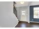 The Foyer features a white front door, hardwood floors, and staircase at 6827 Fallen Leaf Dr, Whitestown, IN 46075
