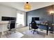 Home office with dual monitor setup, gaming chair, and ample workspace at 6827 Fallen Leaf Dr, Whitestown, IN 46075