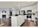Bright kitchen with stainless steel appliances, white cabinets, and large island at 6827 Fallen Leaf Dr, Whitestown, IN 46075
