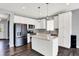 Modern kitchen featuring white cabinets, stainless steel appliances, a large island, and sleek finishes at 6827 Fallen Leaf Dr, Whitestown, IN 46075
