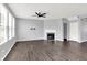 Living room boasts large windows, wood floors, and a cozy fireplace at 6827 Fallen Leaf Dr, Whitestown, IN 46075