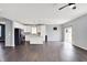 Bright living room with hardwood floors connects to a modern kitchen with stainless steel appliances at 6827 Fallen Leaf Dr, Whitestown, IN 46075
