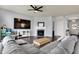 Spacious living area with a fireplace, large TV, and ample natural light at 6827 Fallen Leaf Dr, Whitestown, IN 46075