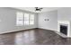 Living room features large windows, ceiling fan, and a fireplace at 6827 Fallen Leaf Dr, Whitestown, IN 46075