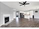 Spacious living room with fireplace that flows into a modern kitchen with white cabinetry and dark appliances at 6827 Fallen Leaf Dr, Whitestown, IN 46075