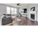 Cozy living room with a fireplace, large windows, and comfortable seating at 6827 Fallen Leaf Dr, Whitestown, IN 46075